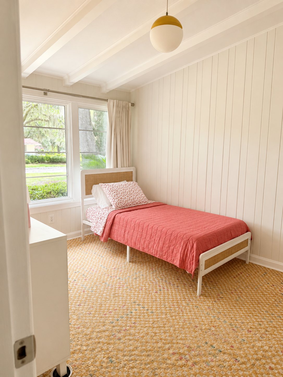 Third bedroom with paneled walls and checkered carpet