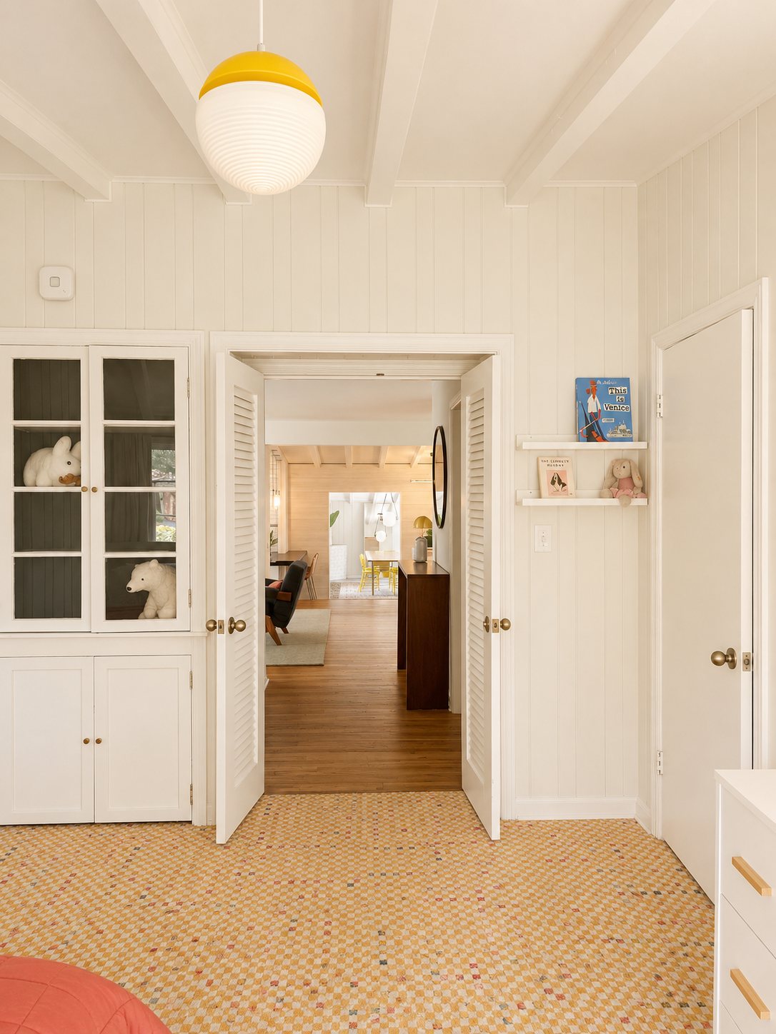 Original built-in cabinets with louvered double doors to the main living space